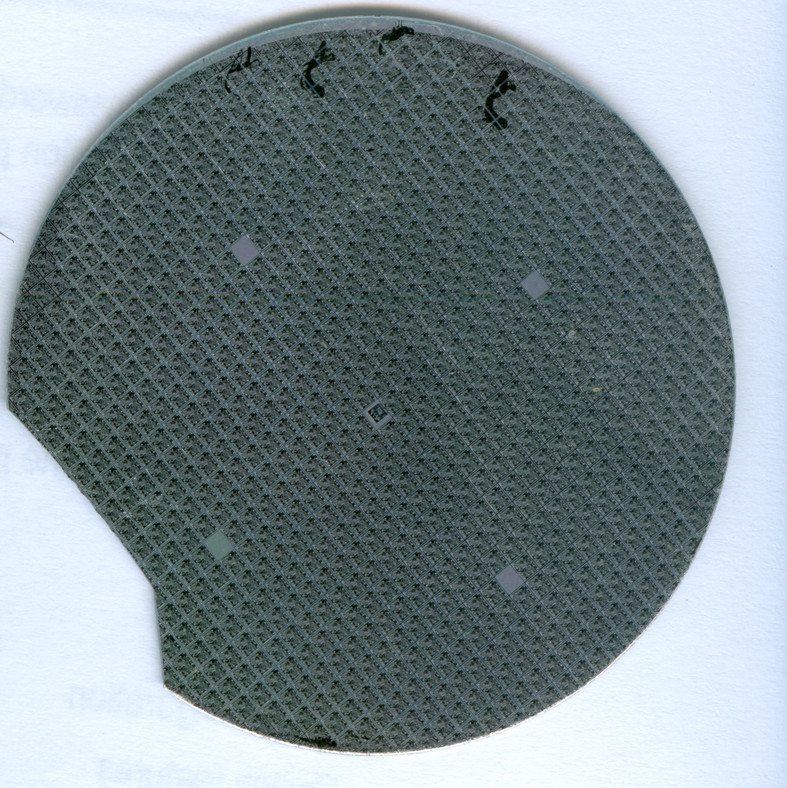 High-resolution photograph of a silicon semiconductor wafer with hundreds of microprocessor dies arranged in a grid pattern across its mirrored surface